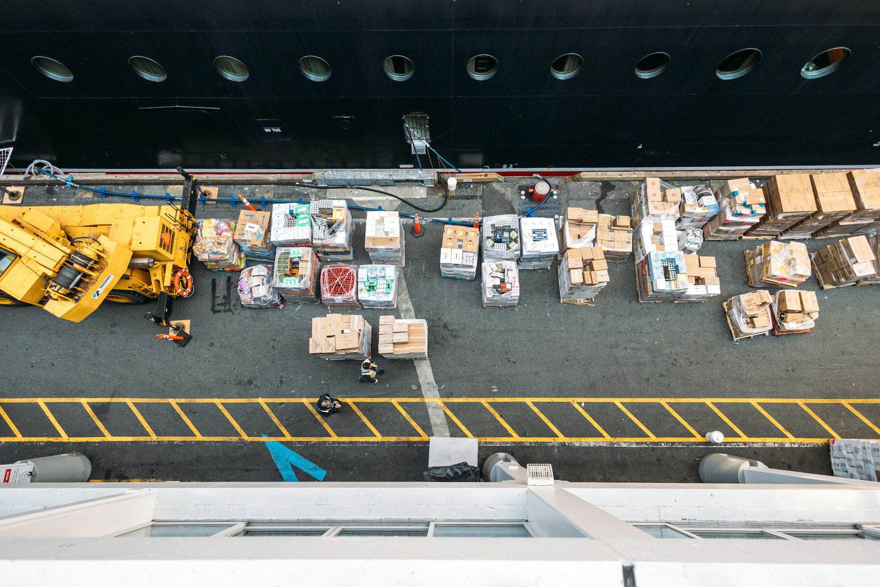Overhead view of cargo being loaded onto a ship.
